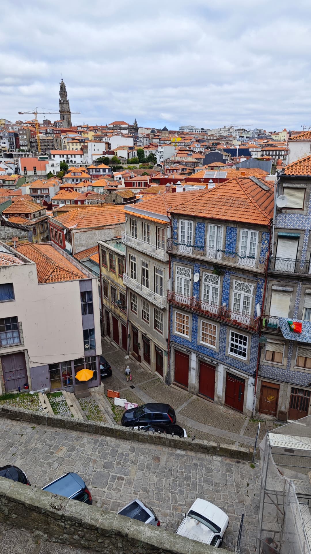 View over Porto's terracotta rooftops and tiled façades from a cobbled street